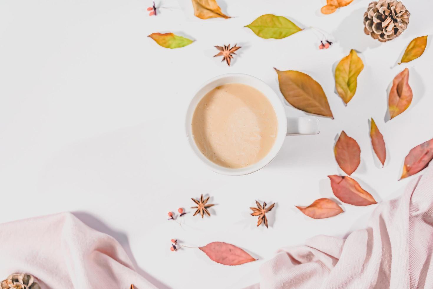 Autumn composition. Cup of coffee, autumn leaves , cinnamon sticks and anise stars on Bright Blue pastel  background. Flat lay, top view copy space. photo