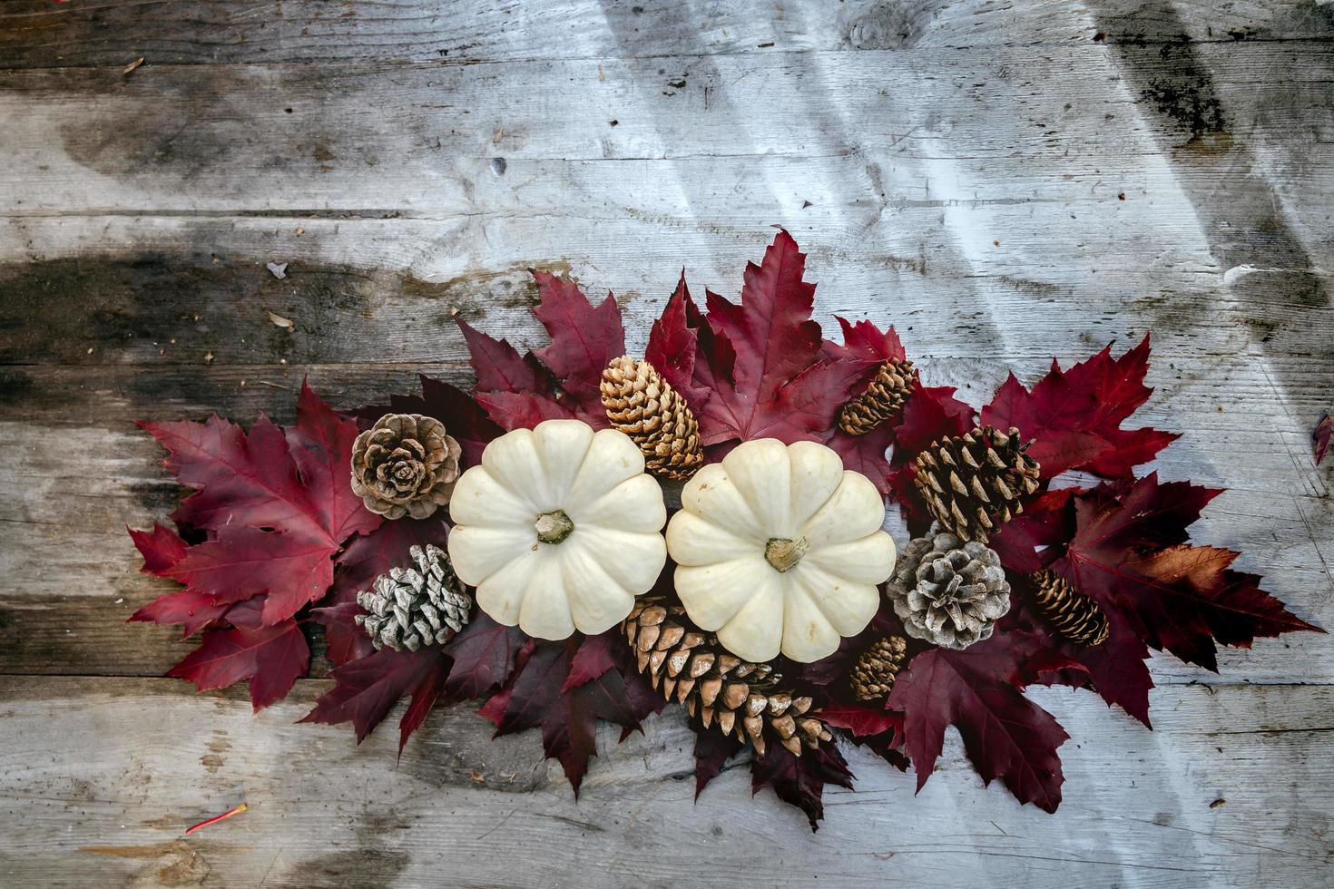 Festive autumn decor from pumpkins, pine and leaves on a  wooden background. Concept of Thanksgiving day or Halloween. Flat lay autumn composition with copy space. photo
