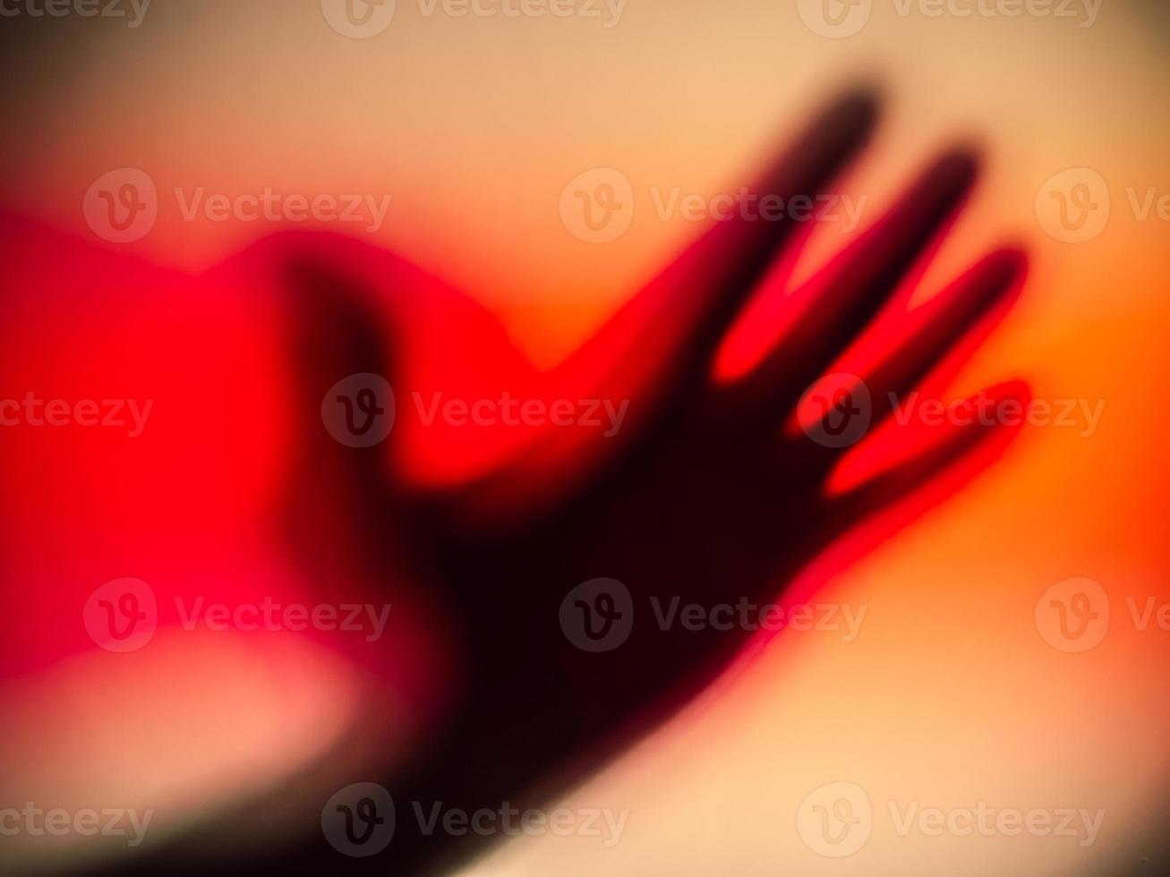 A bloody shadow of a silhouetted hand. photo