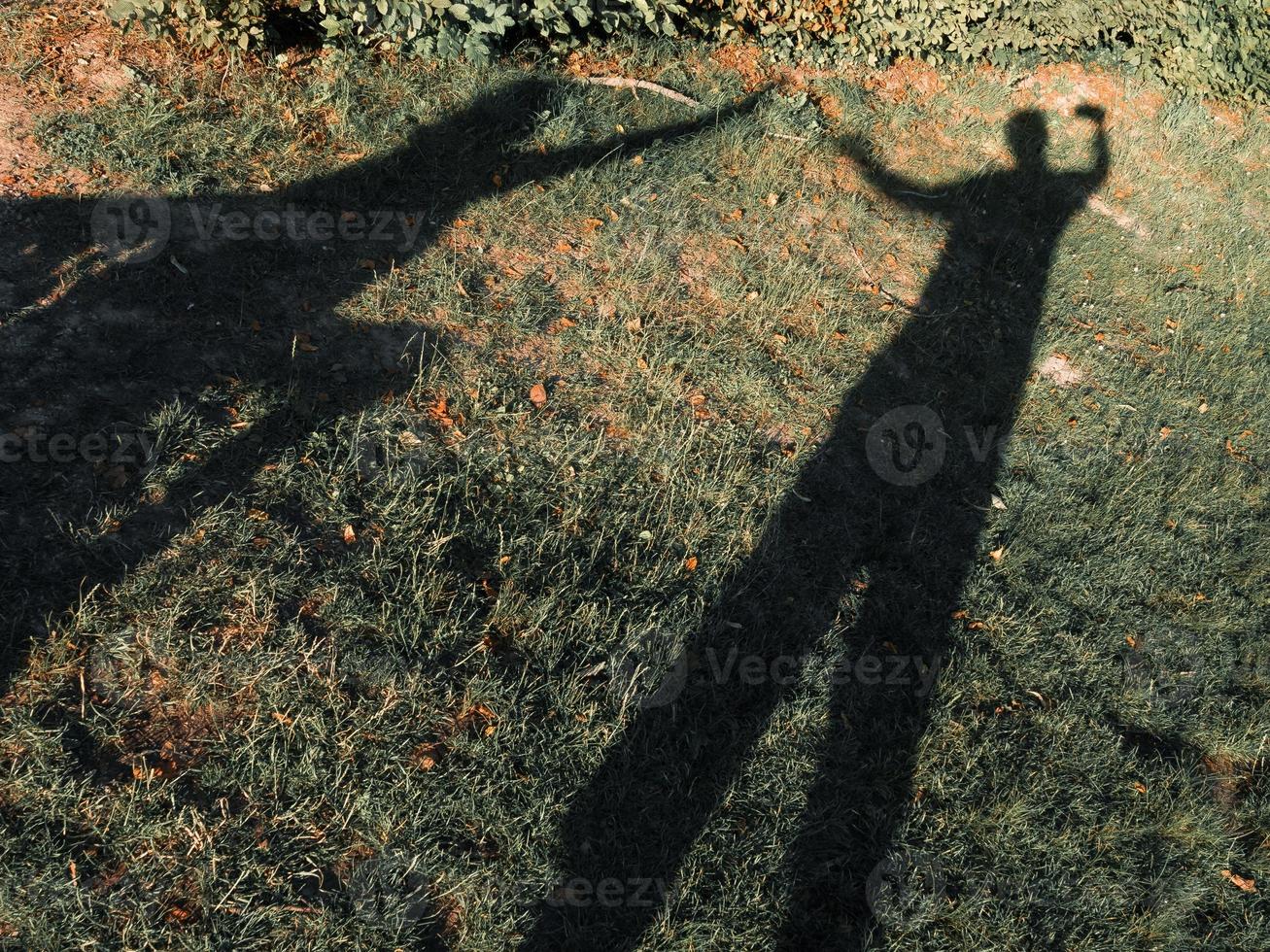 Shadows of a lovely couple under bright sunlight in summer. photo