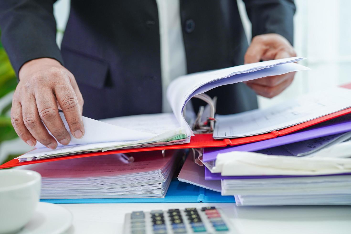 Businessman working and prepare paperwork report data to analysis information in file binder at office. photo