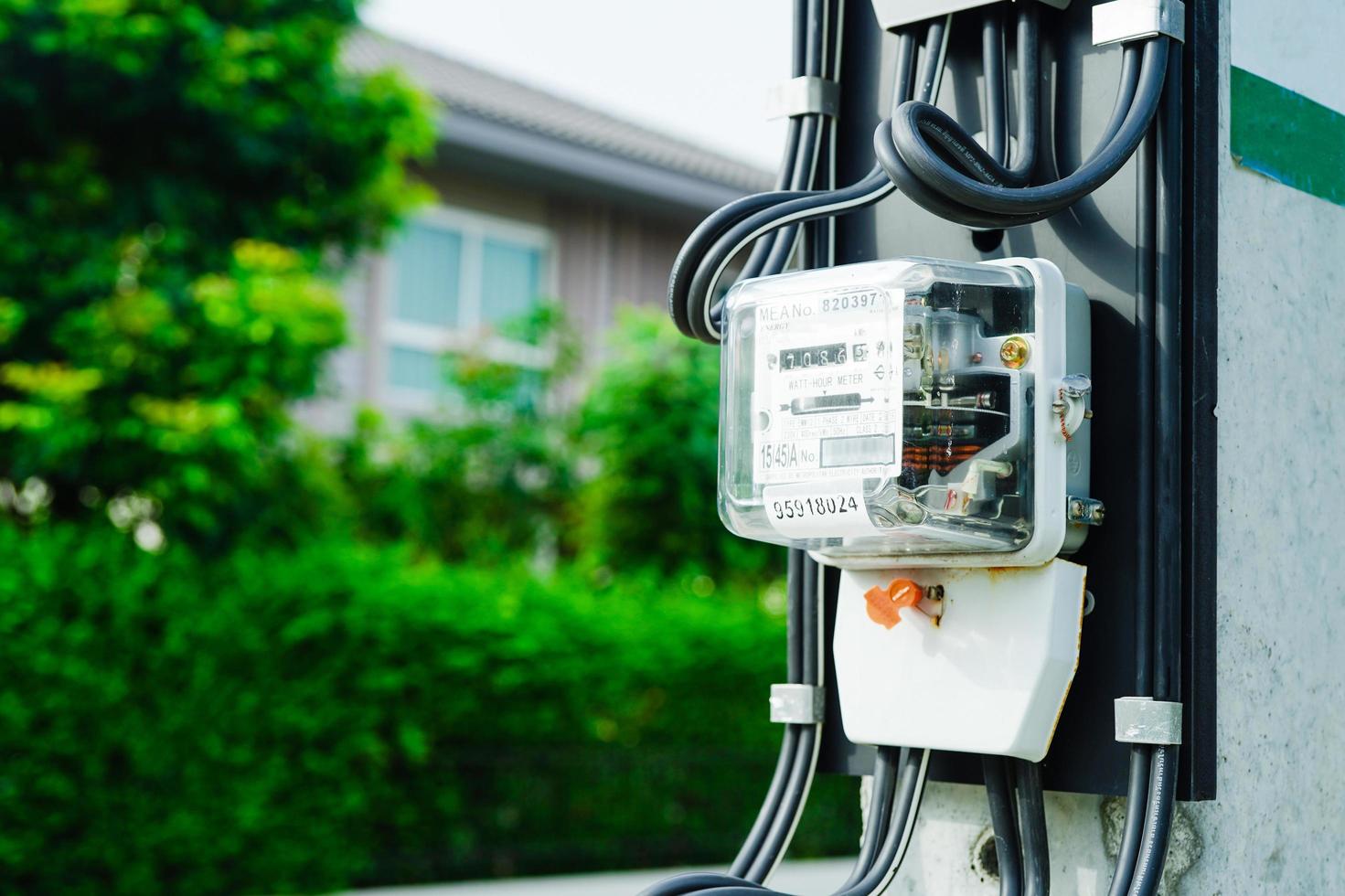 Electric measuring power meter for energy cost at home and office, solar cell concept. photo
