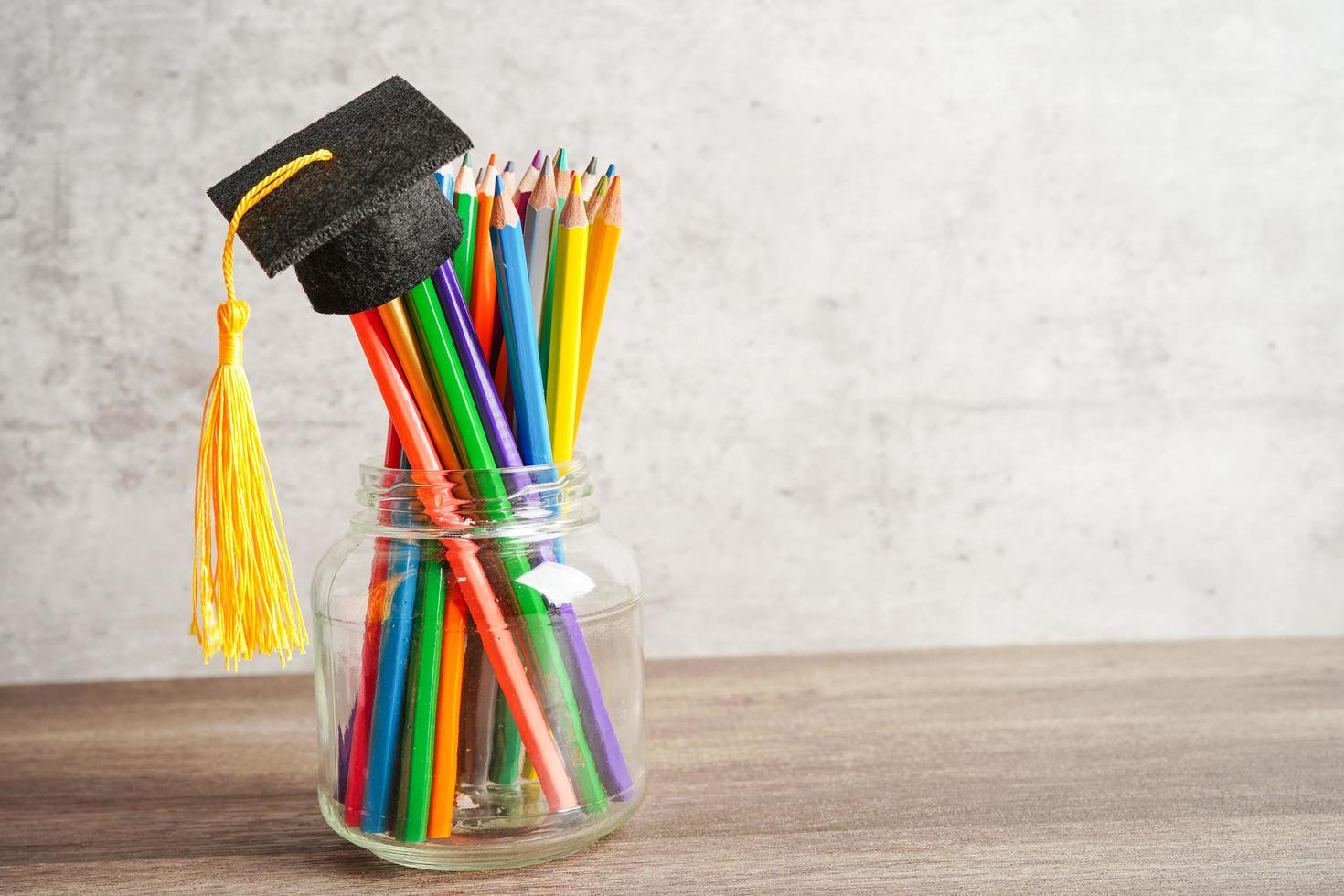Colorful pencils in glass jar with copy space, learning university education concept. photo