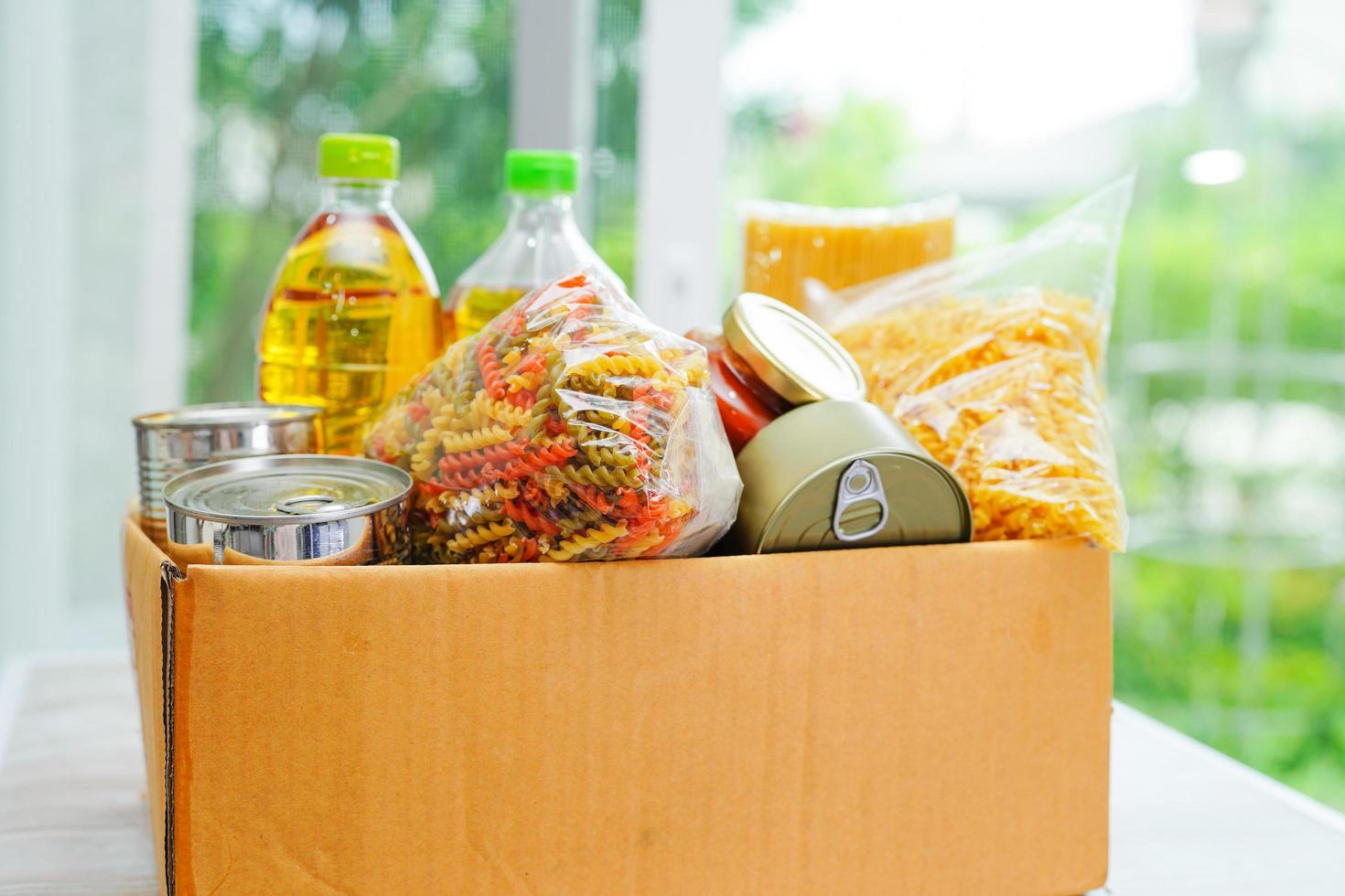 Foodstuffs in donation box for volunteer. photo