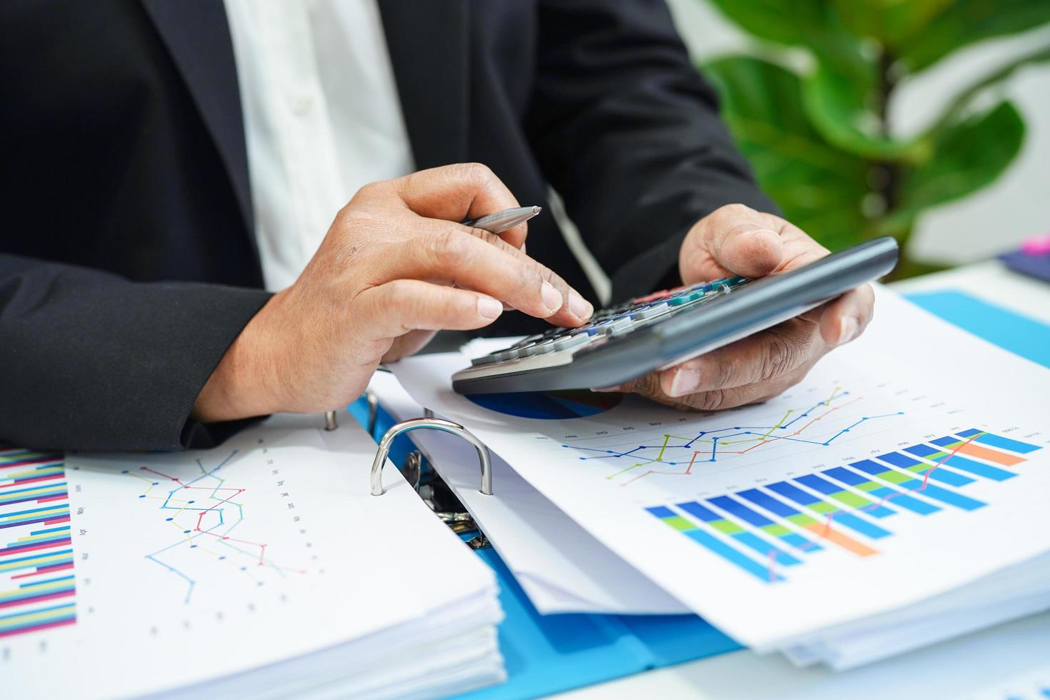 Business woman working and analysis with statistic graph in office. photo