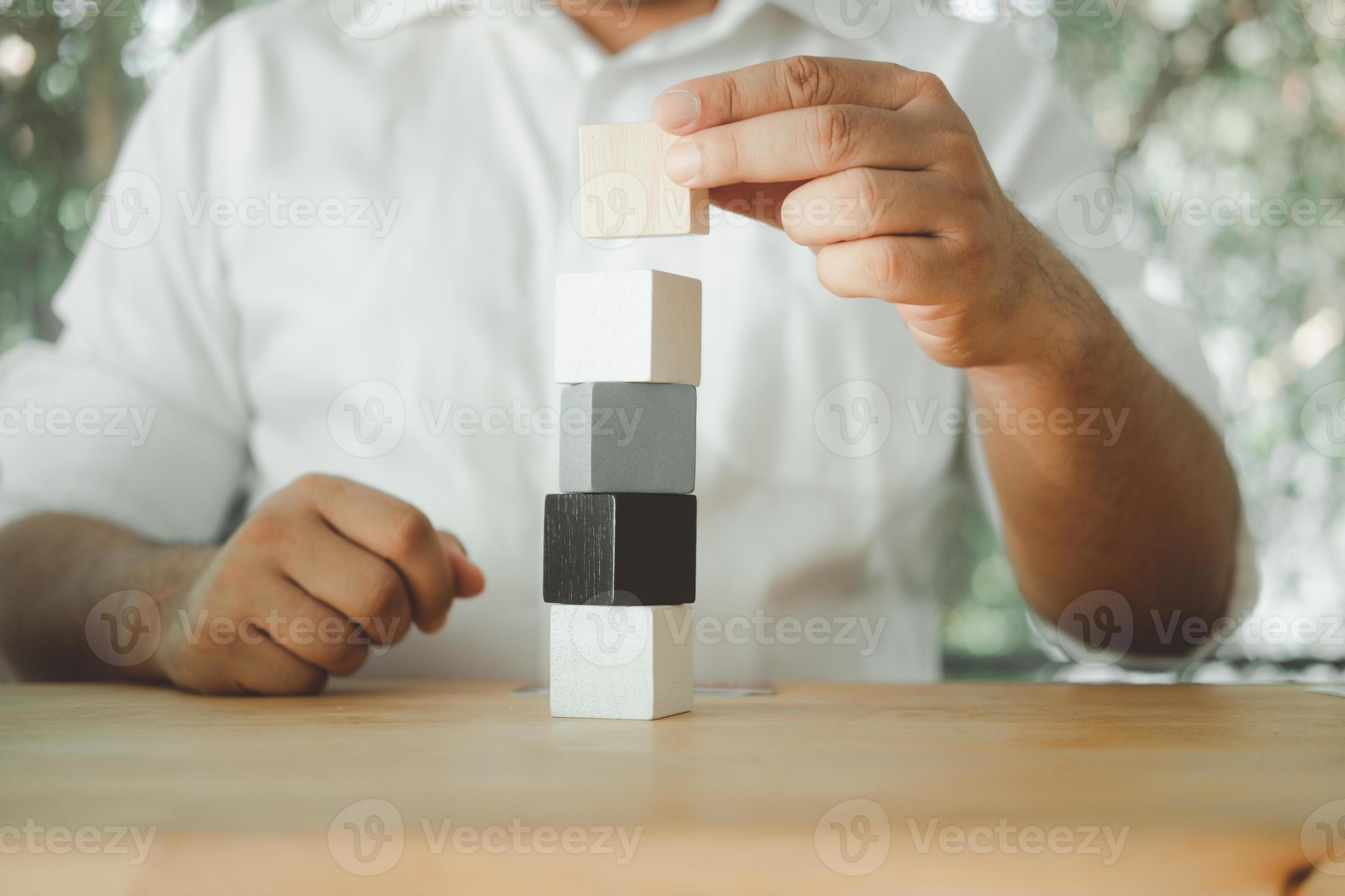 Man piling up and stacking a wooden block. 10303457 Stock Photo at Vecteezy