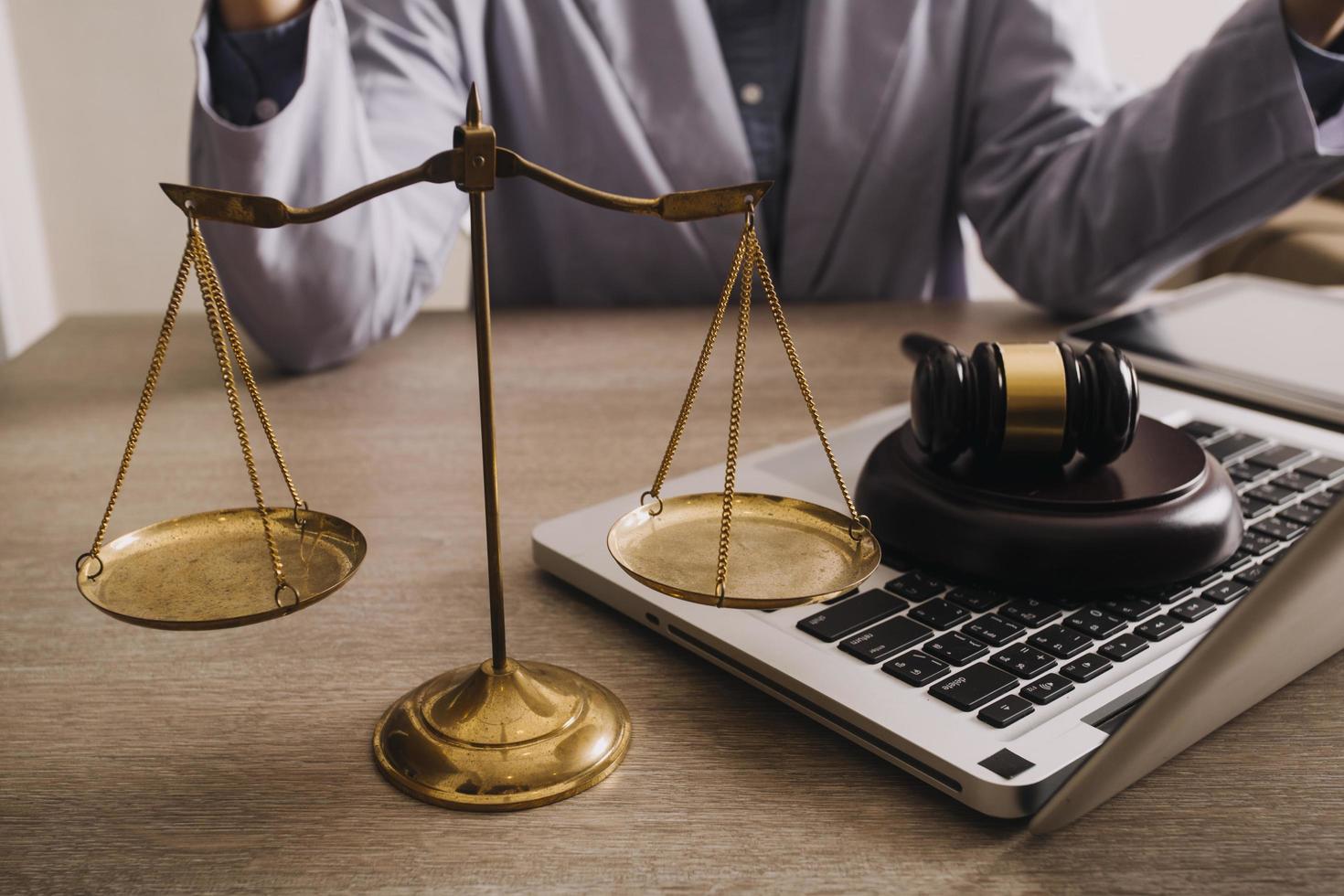 Male lawyer working with contract papers and wooden gavel on tabel in courtroom. justice and law ,attorney, court judge, concept. photo