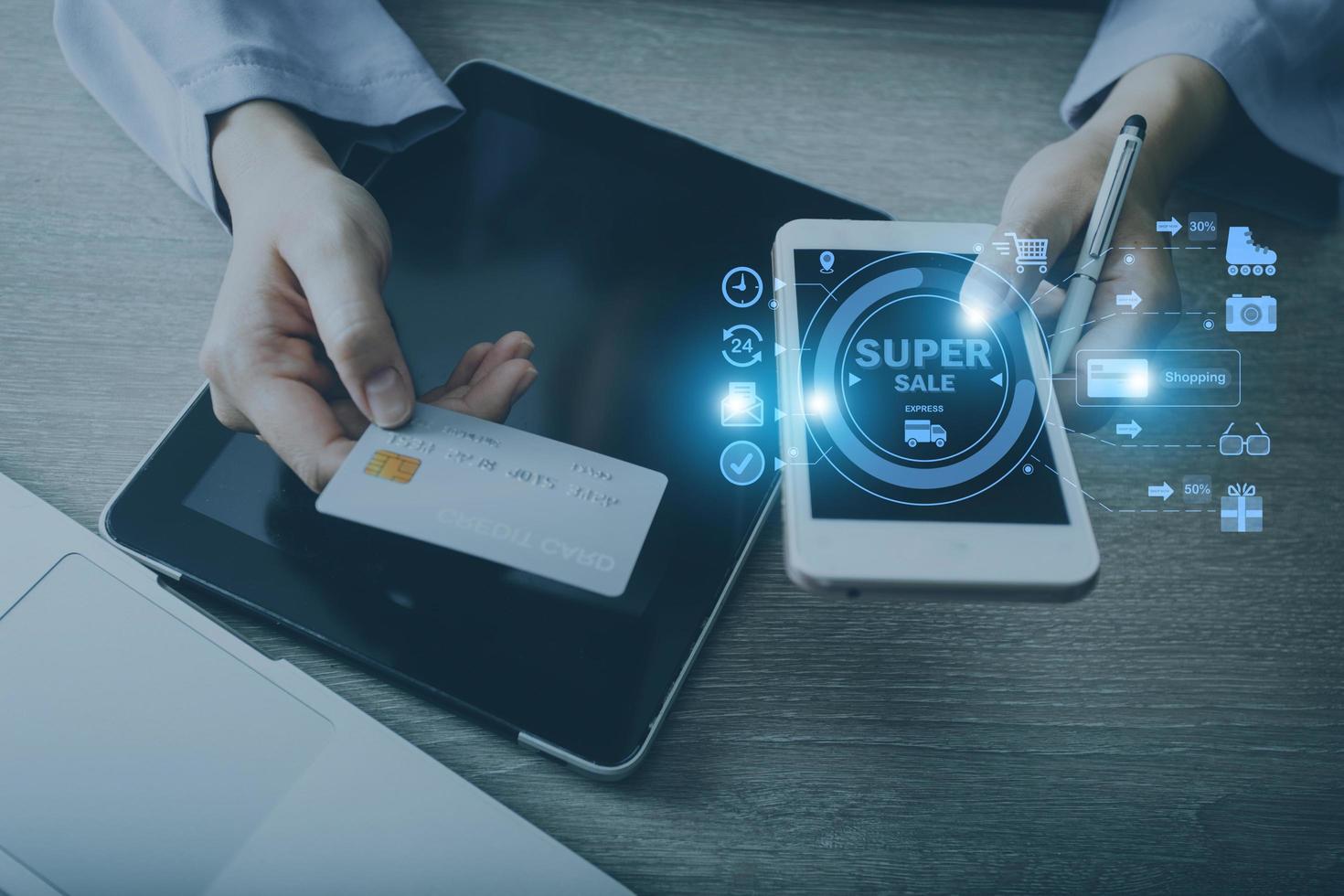 Hands holding credit card and using laptop. Online shopping photo