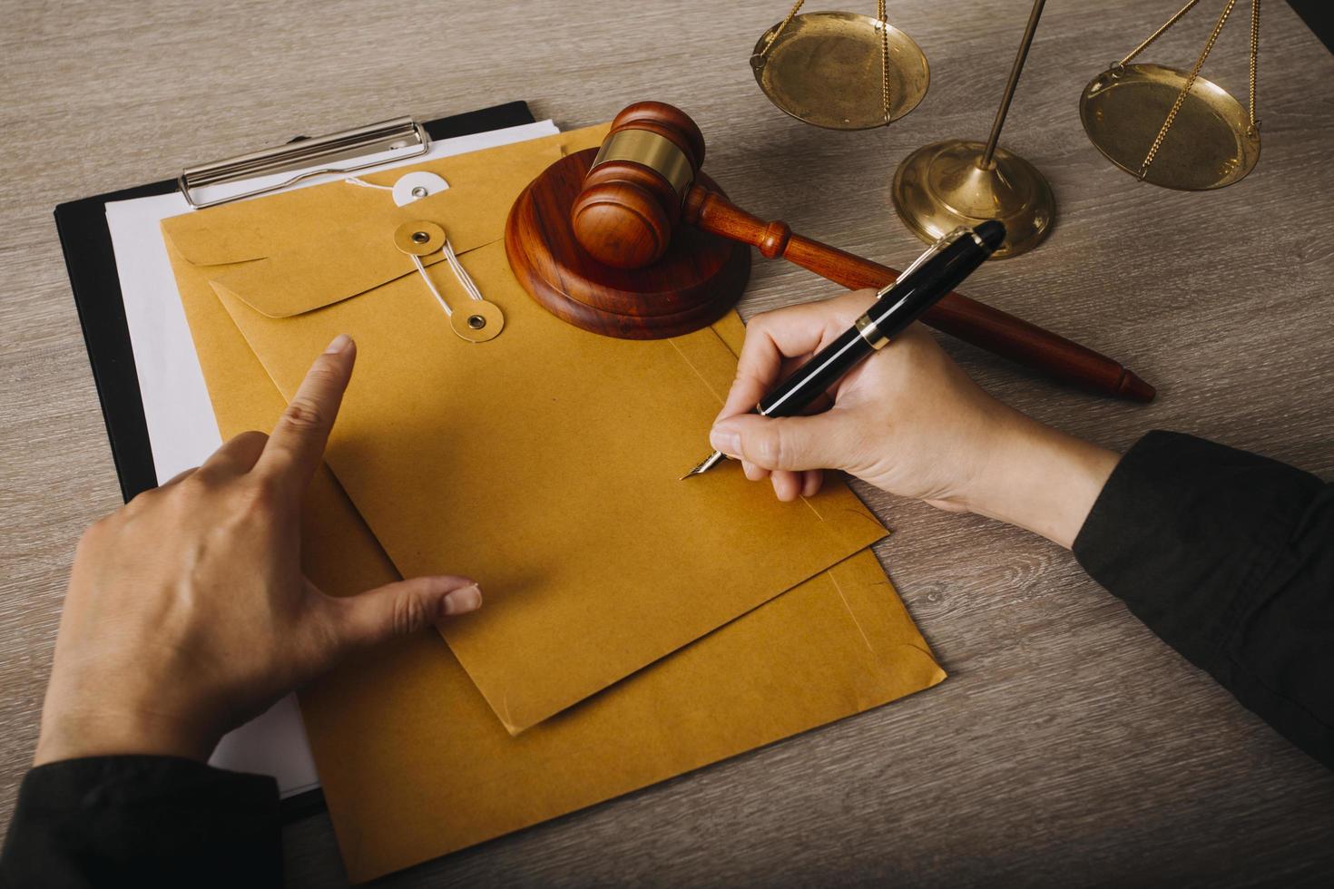 Male lawyer working with contract papers and wooden gavel on tabel in courtroom. justice and law ,attorney, court judge, concept. photo