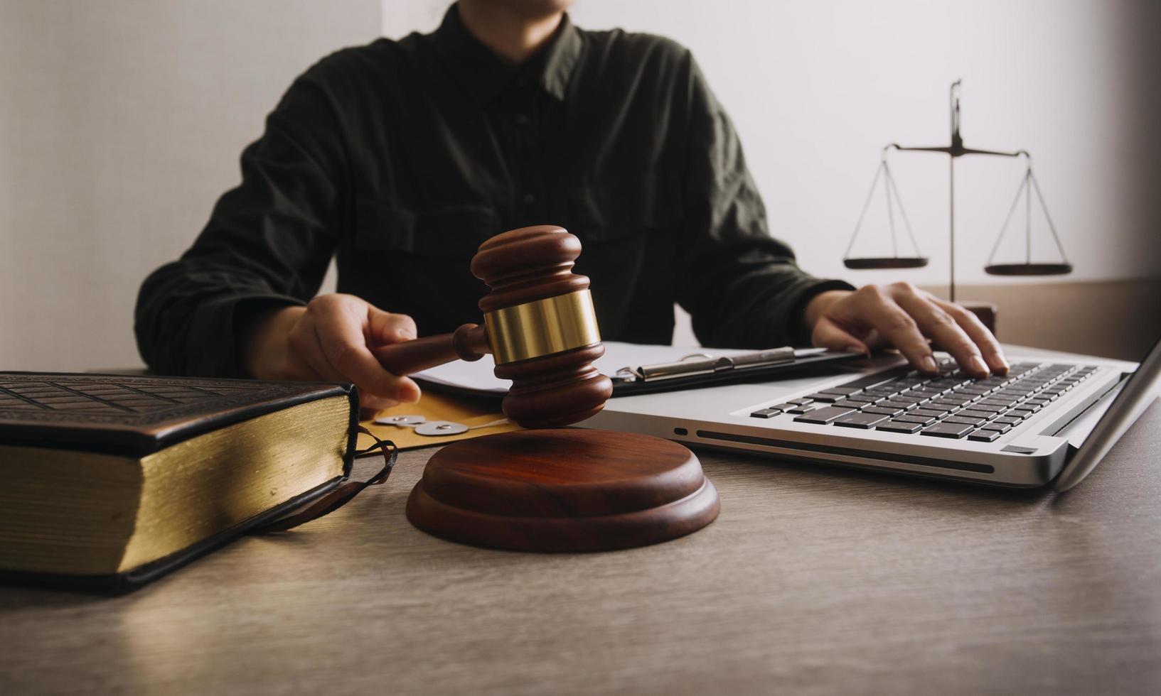 Male lawyer working with contract papers and wooden gavel on tabel in courtroom. justice and law ,attorney, court judge, concept. photo