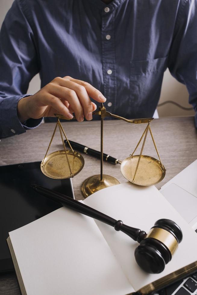 Male lawyer working with contract papers and wooden gavel on tabel in courtroom. justice and law ,attorney, court judge, concept. photo