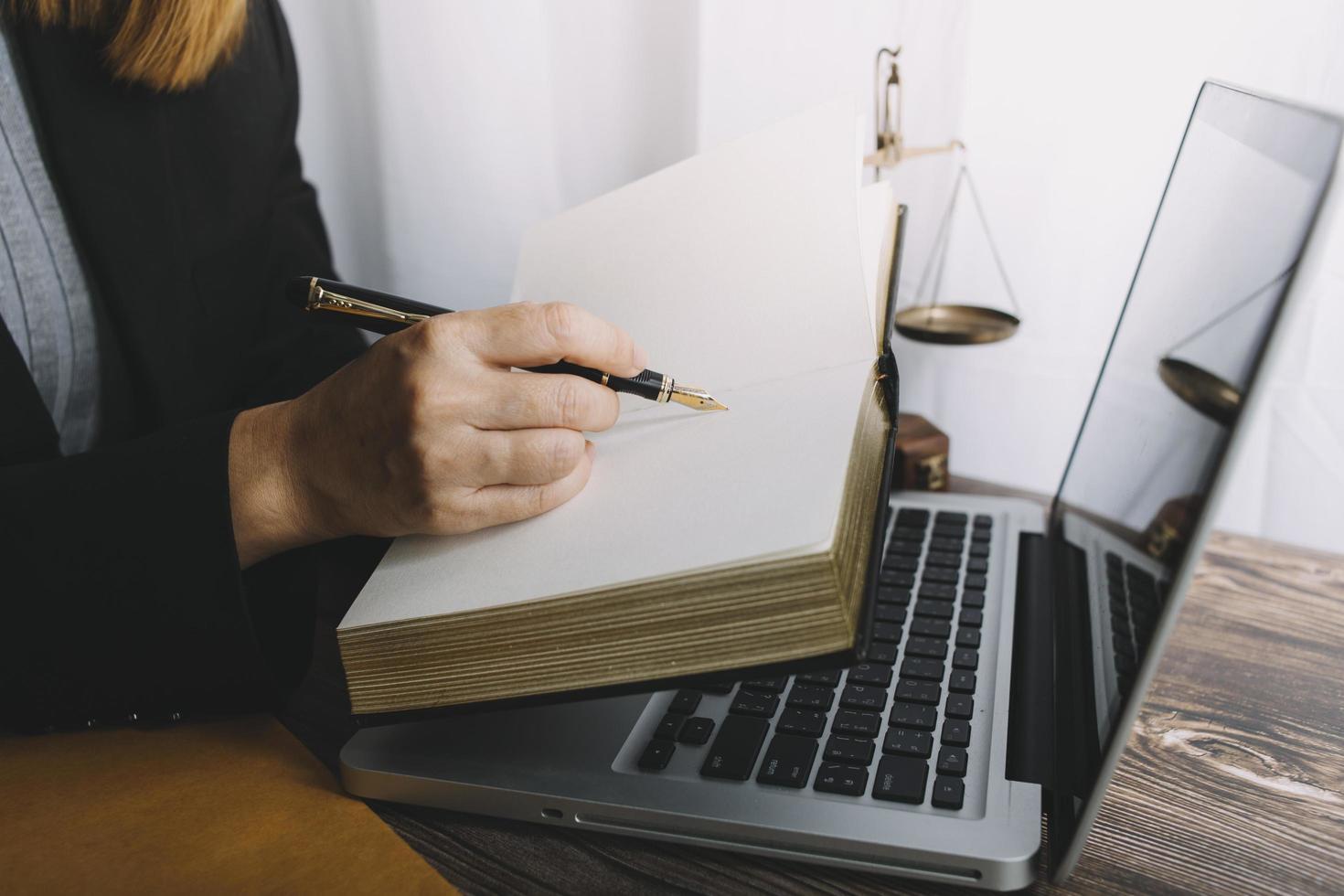 Business and lawyers discussing contract papers with brass scale on desk in office. Law, legal services, advice, justice and law concept picture with film grain effect photo