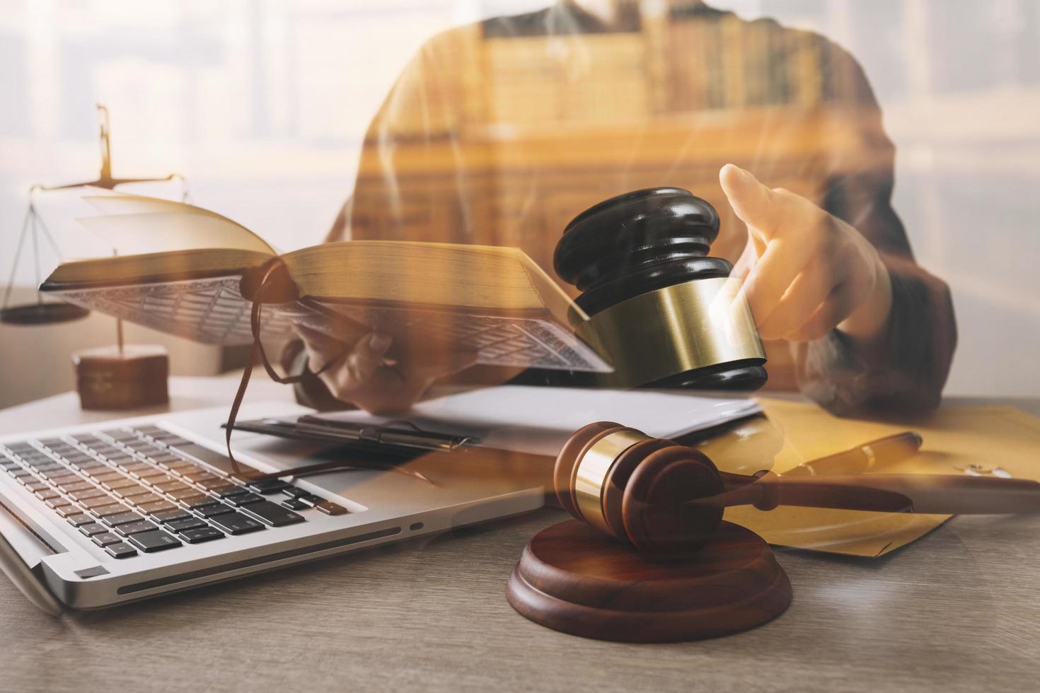 Male lawyer working with contract papers and wooden gavel on tabel in courtroom. justice and law ,attorney, court judge, concept. photo