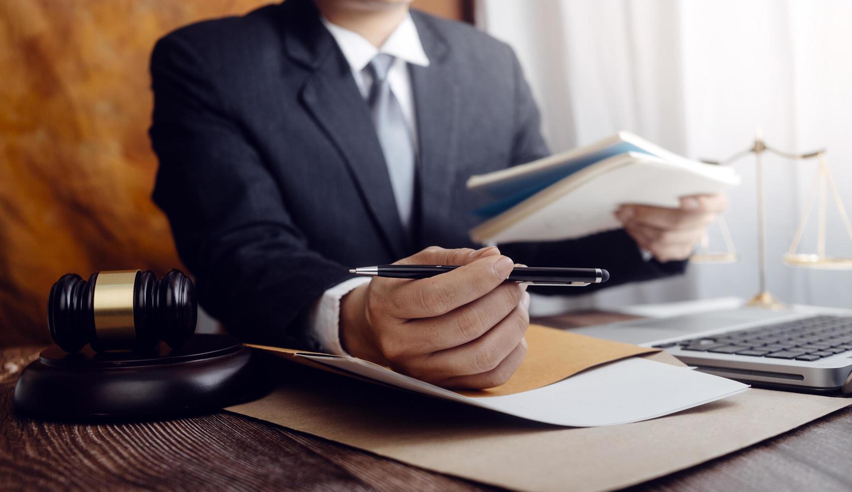 Business and lawyers discussing contract papers with brass scale on desk in office. Law, legal services, advice, justice and law concept picture with film grain effect photo