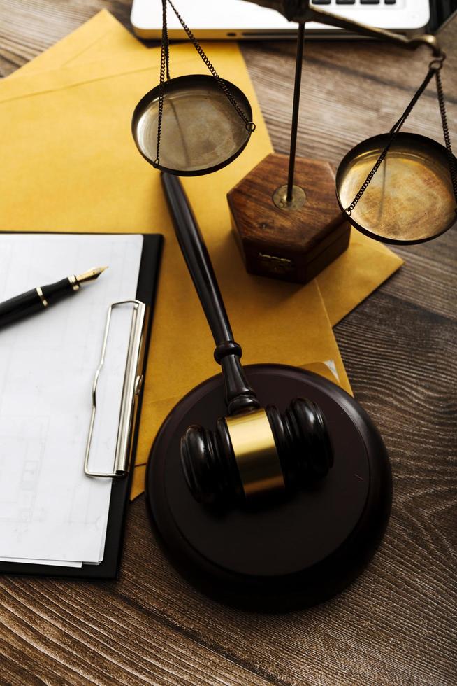 Business and lawyers discussing contract papers with brass scale on desk in office. Law, legal services, advice, justice and law concept picture with film grain effect photo