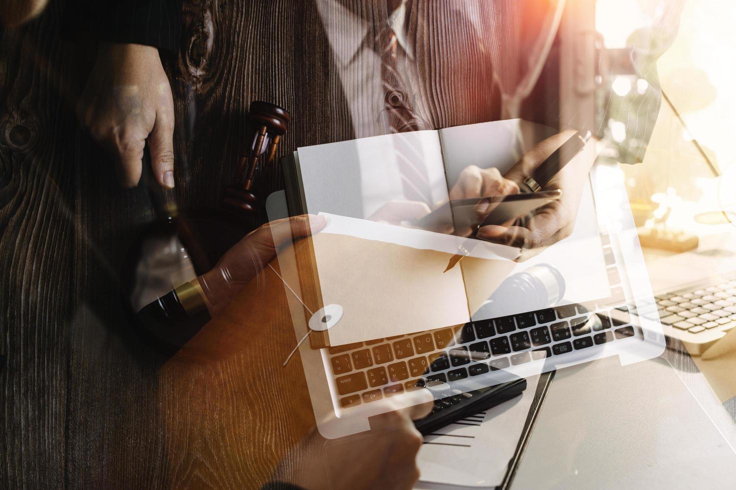 Business and lawyers discussing contract papers with brass scale on desk in office. Law, legal services, advice, justice and law concept picture with film grain effect photo