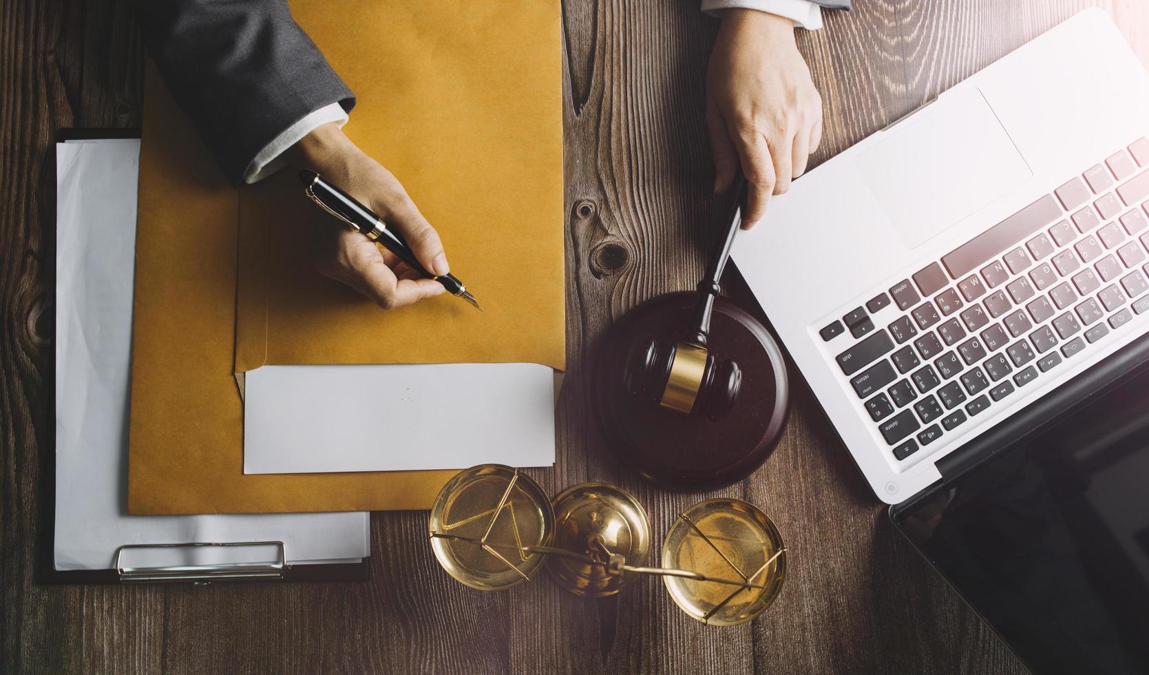 justice and law concept.Male judge in a courtroom on wooden table and Counselor or Male lawyer working in office. Legal law, advice and justice concept. photo