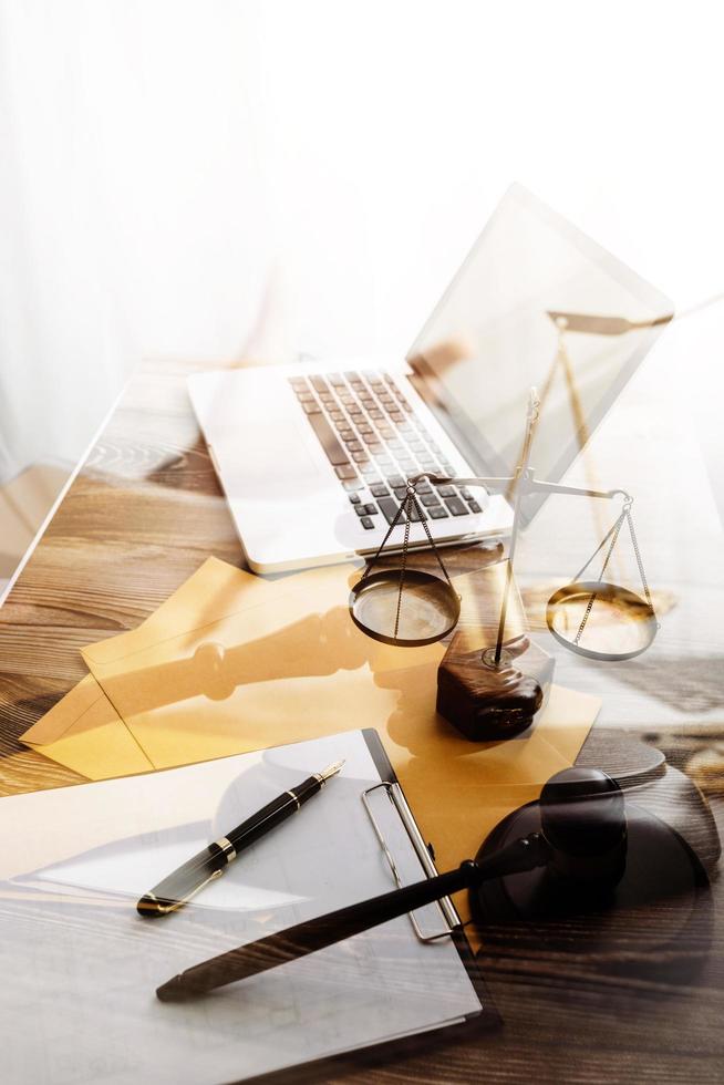 Business and lawyers discussing contract papers with brass scale on desk in office. Law, legal services, advice, justice and law concept picture with film grain effect photo