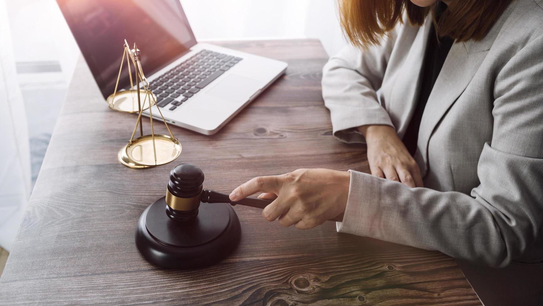 Business and lawyers discussing contract papers with brass scale on desk in office. Law, legal services, advice, justice and law concept picture with film grain effect photo