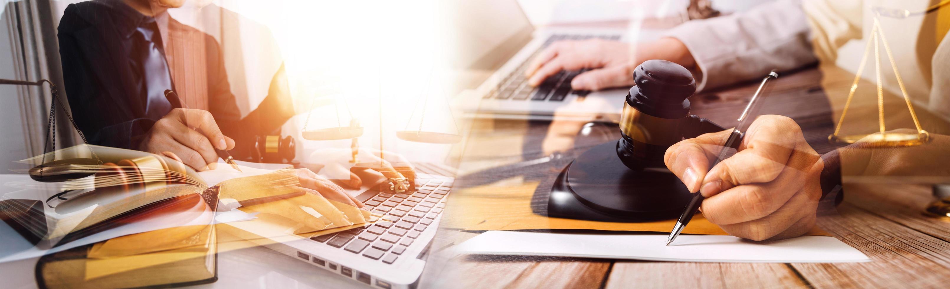 Justice and law concept.Male judge in a courtroom with the gavel, working with, computer and docking keyboard, eyeglasses, on table in morning light photo