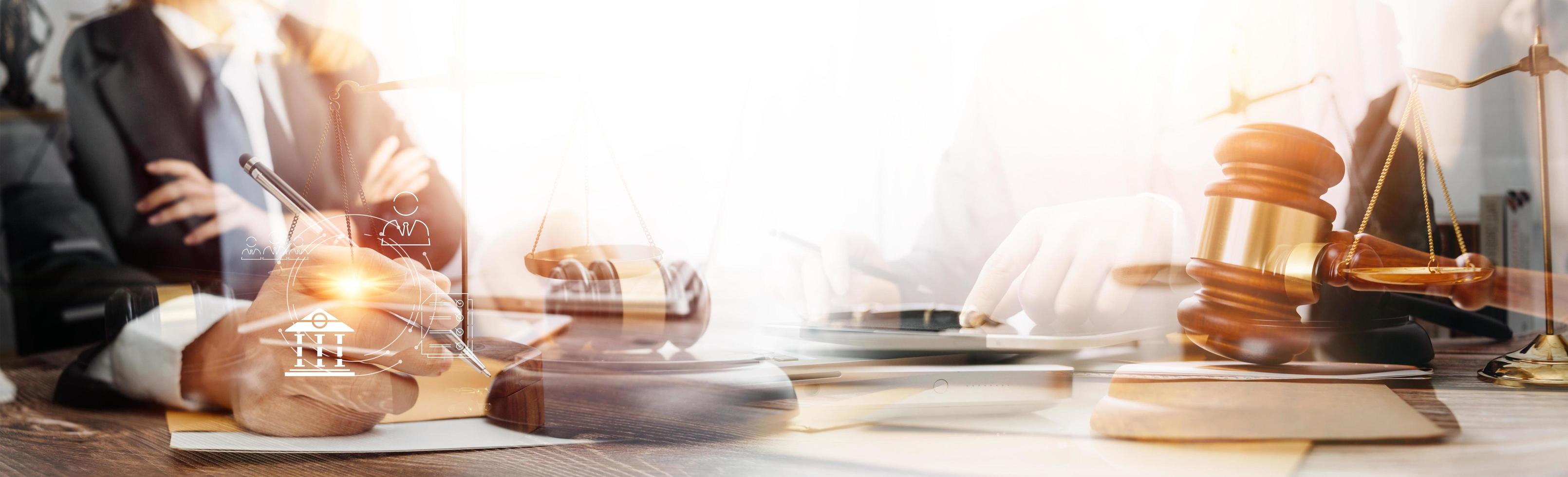 Justice and law concept.Male judge in a courtroom with the gavel, working with, computer and docking keyboard, eyeglasses, on table in morning light photo