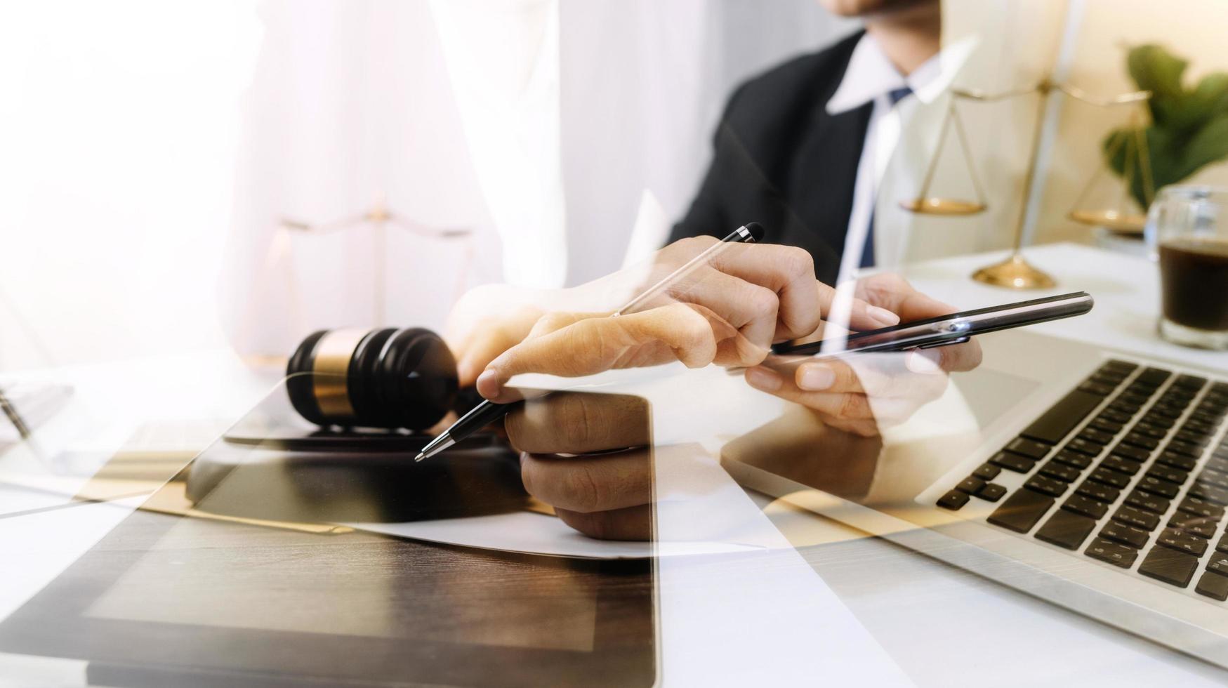 Business and lawyers discussing contract papers with brass scale on desk in office. Law, legal services, advice, justice and law concept picture with film grain effect photo