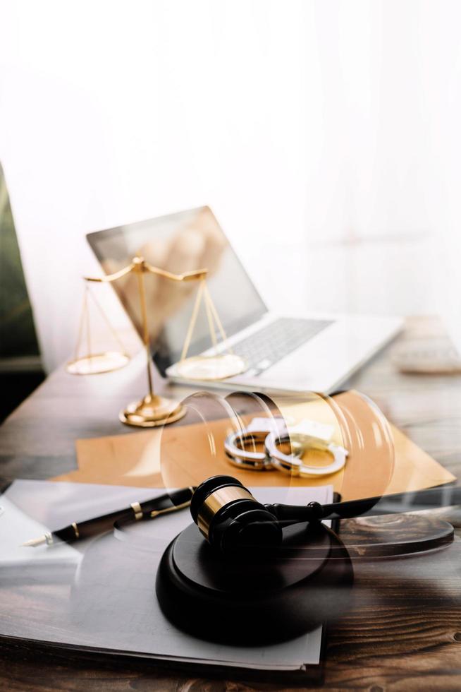 Business and lawyers discussing contract papers with brass scale on desk in office. Law, legal services, advice, justice and law concept picture with film grain effect photo