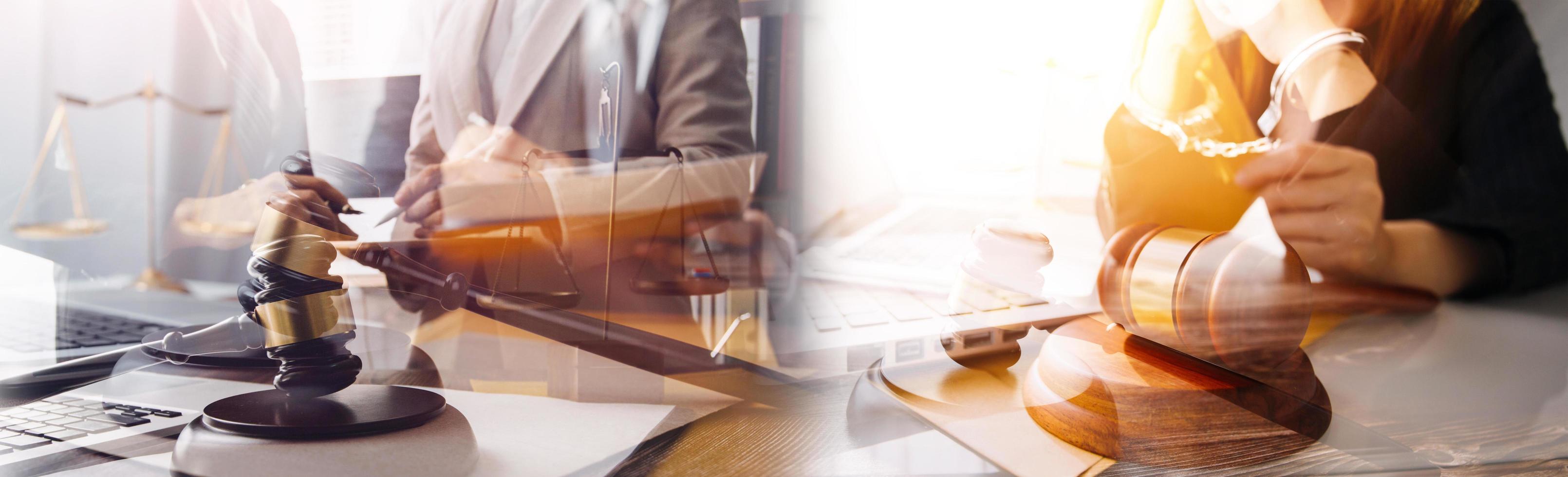 Justice and law concept.Male judge in a courtroom with the gavel, working with, computer and docking keyboard, eyeglasses, on table in morning light photo