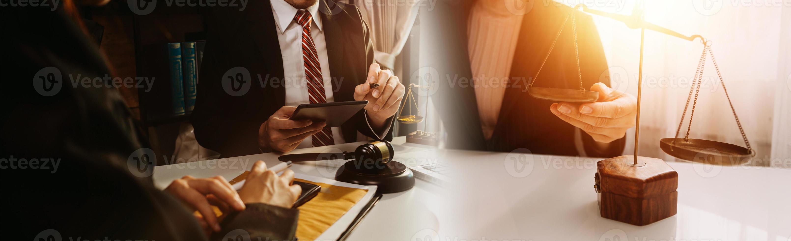 Justice and law concept.Male judge in a courtroom with the gavel, working with, computer and docking keyboard, eyeglasses, on table in morning light photo