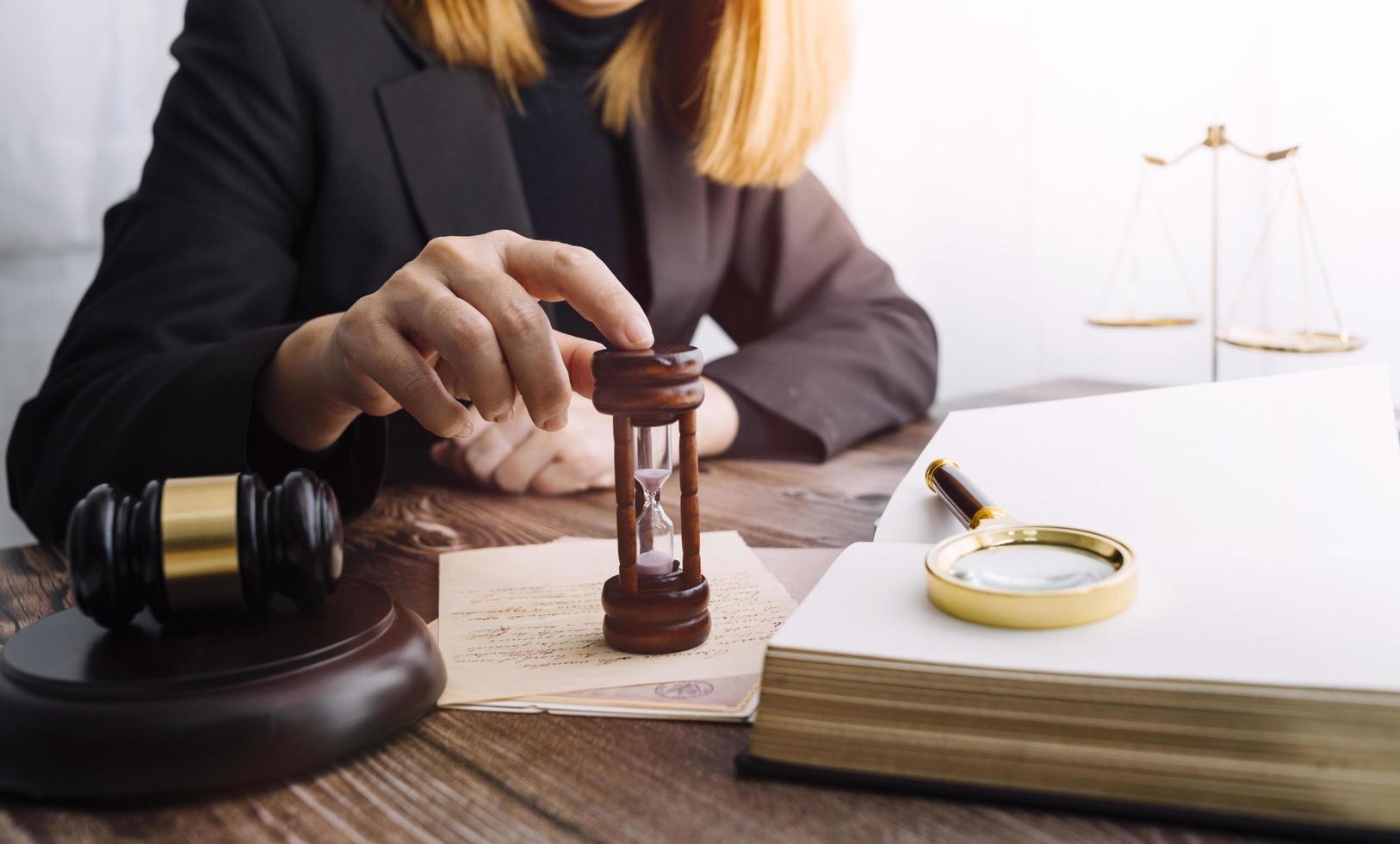 Business and lawyers discussing contract papers with brass scale on desk in office. Law, legal services, advice, justice and law concept picture with film grain effect photo