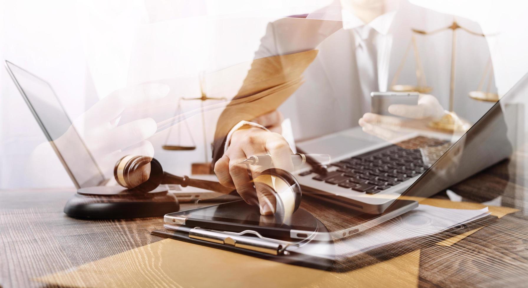 Business and lawyers discussing contract papers with brass scale on desk in office. Law, legal services, advice, justice and law concept picture with film grain effect photo