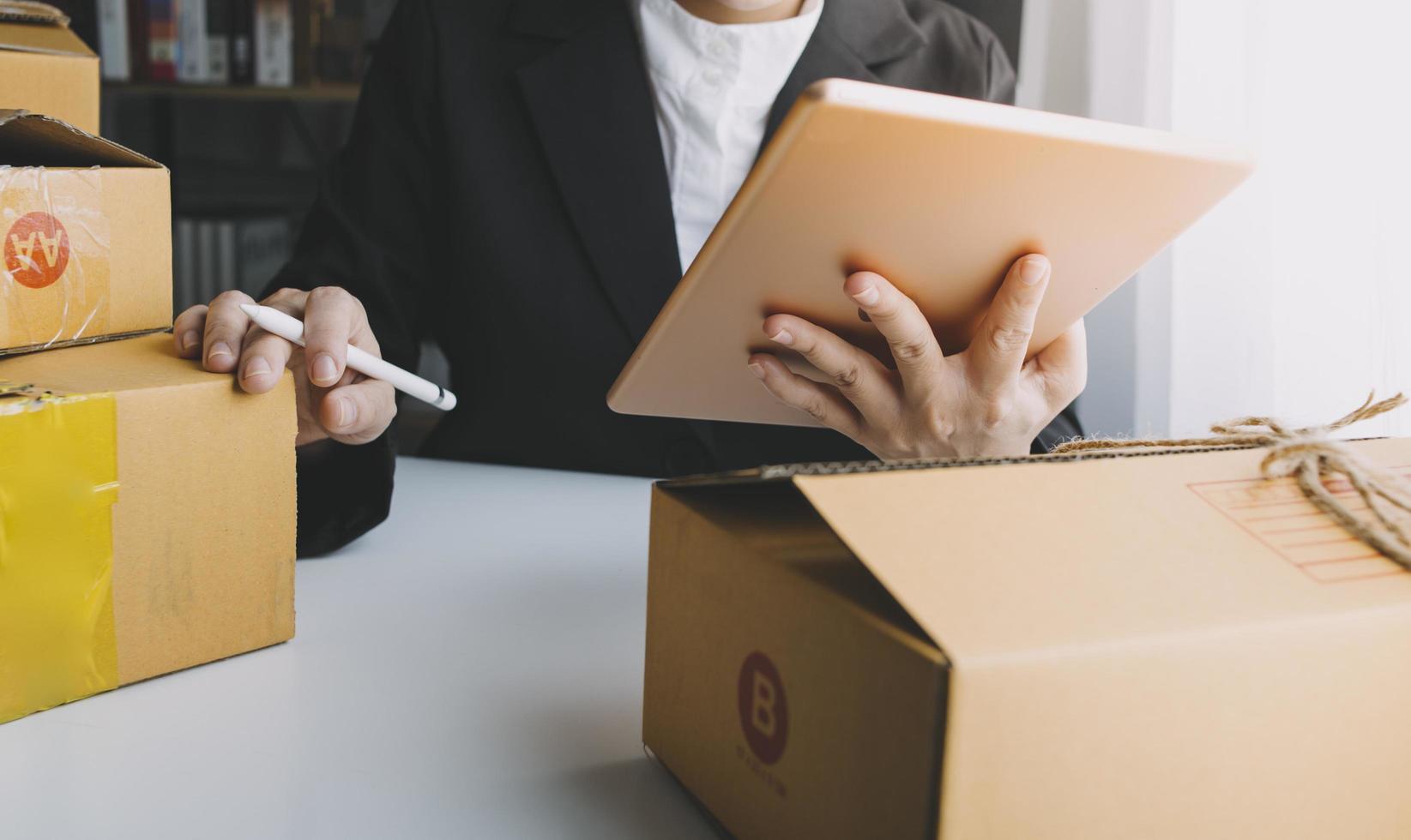 Business woman start up small business entrepreneur SME success .freelance woman working at home with Online Parcel delivery. SME and packaging deliveryconcept photo