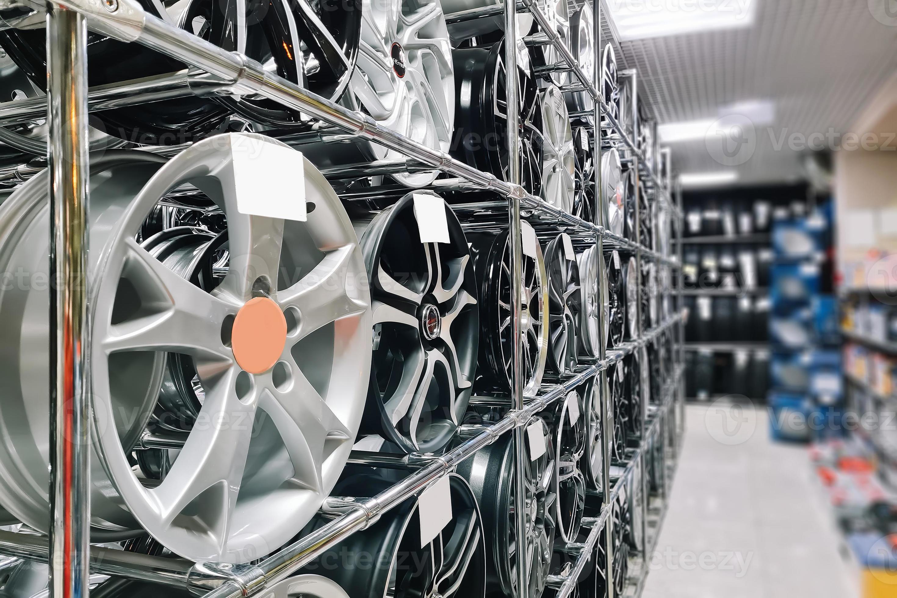 Auto shop selling car rims. Stand for sale of alloy wheels. Discounts at auto parts store