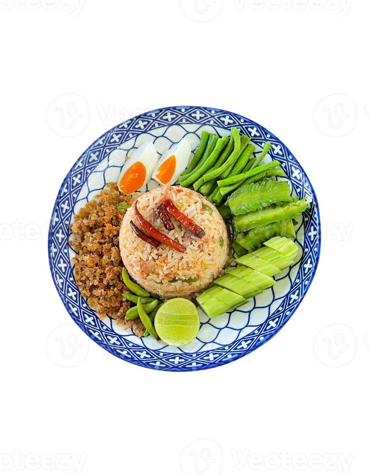 Chili Paste Fried Rice Served with fresh vegetables and salted egg. Isolated on white background. Thai food. photo