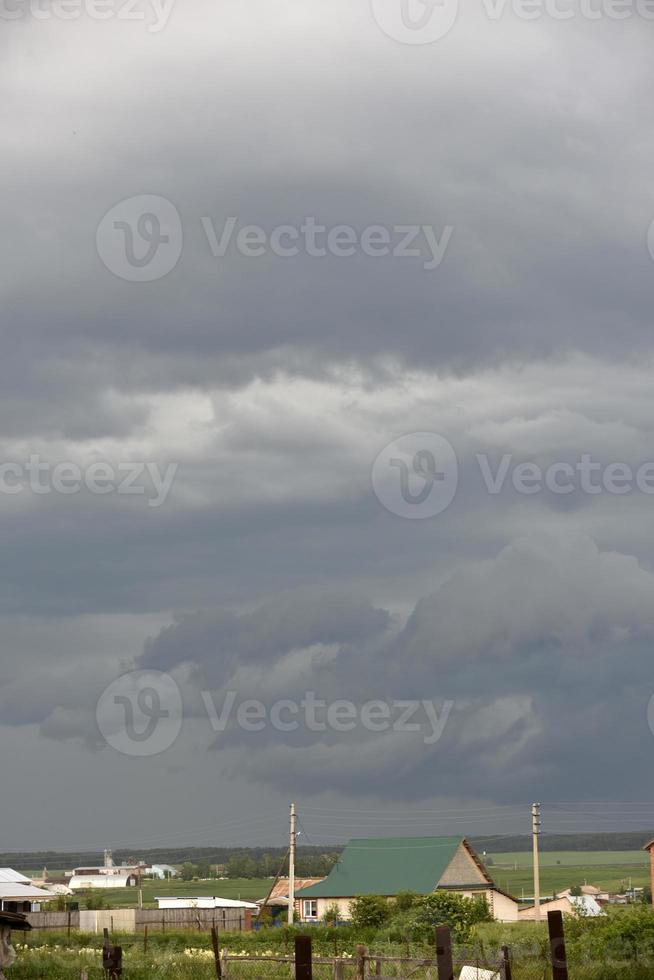 Black thunderstorm storm clouds on the horizon on a summer day. photo