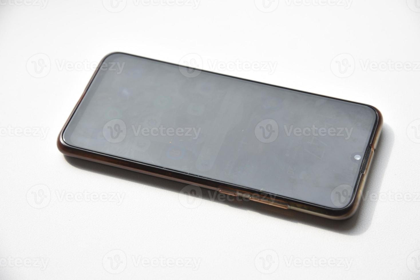 A black smartphone on a white background. photo