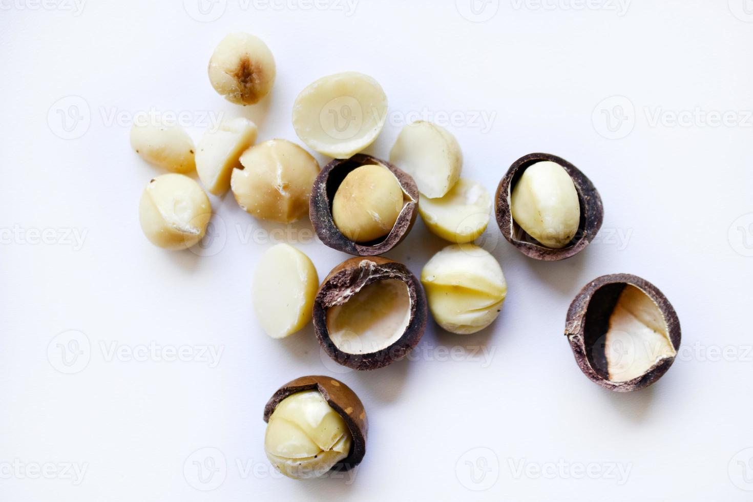 Whole nut and Macadamia kernel on a white background. Delicious whole nuts. photo