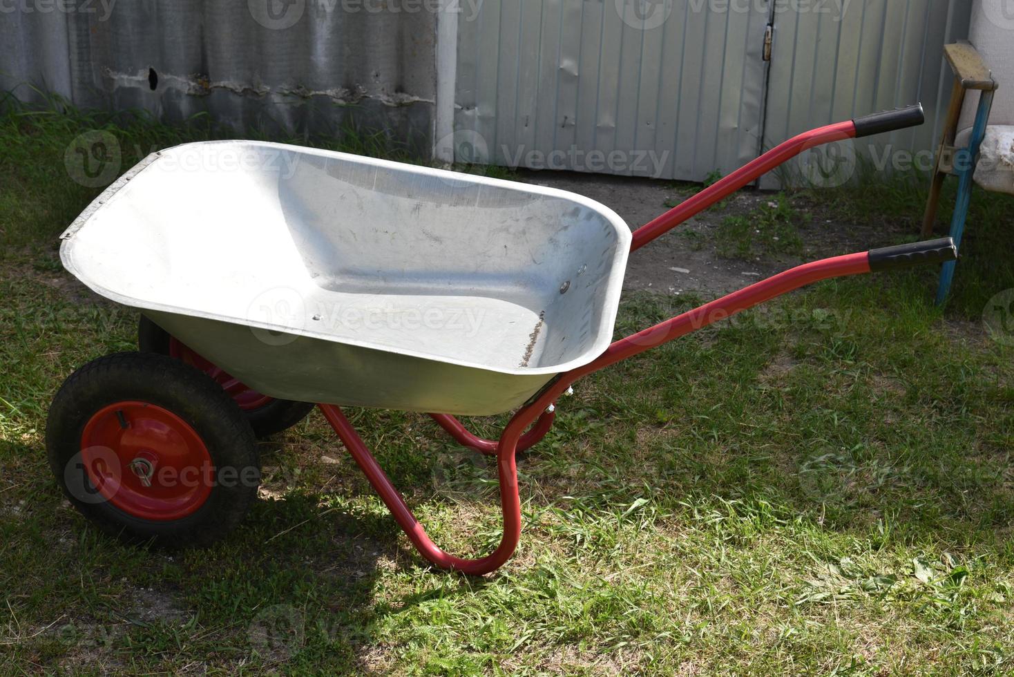 An empty garden iron cart in a summer park photo