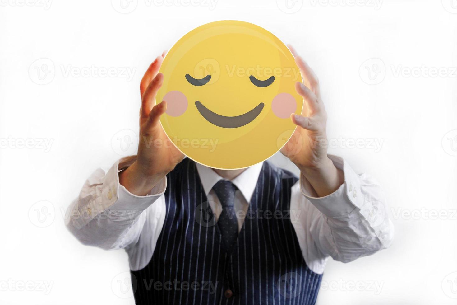 Businessman holding up a smiley photo