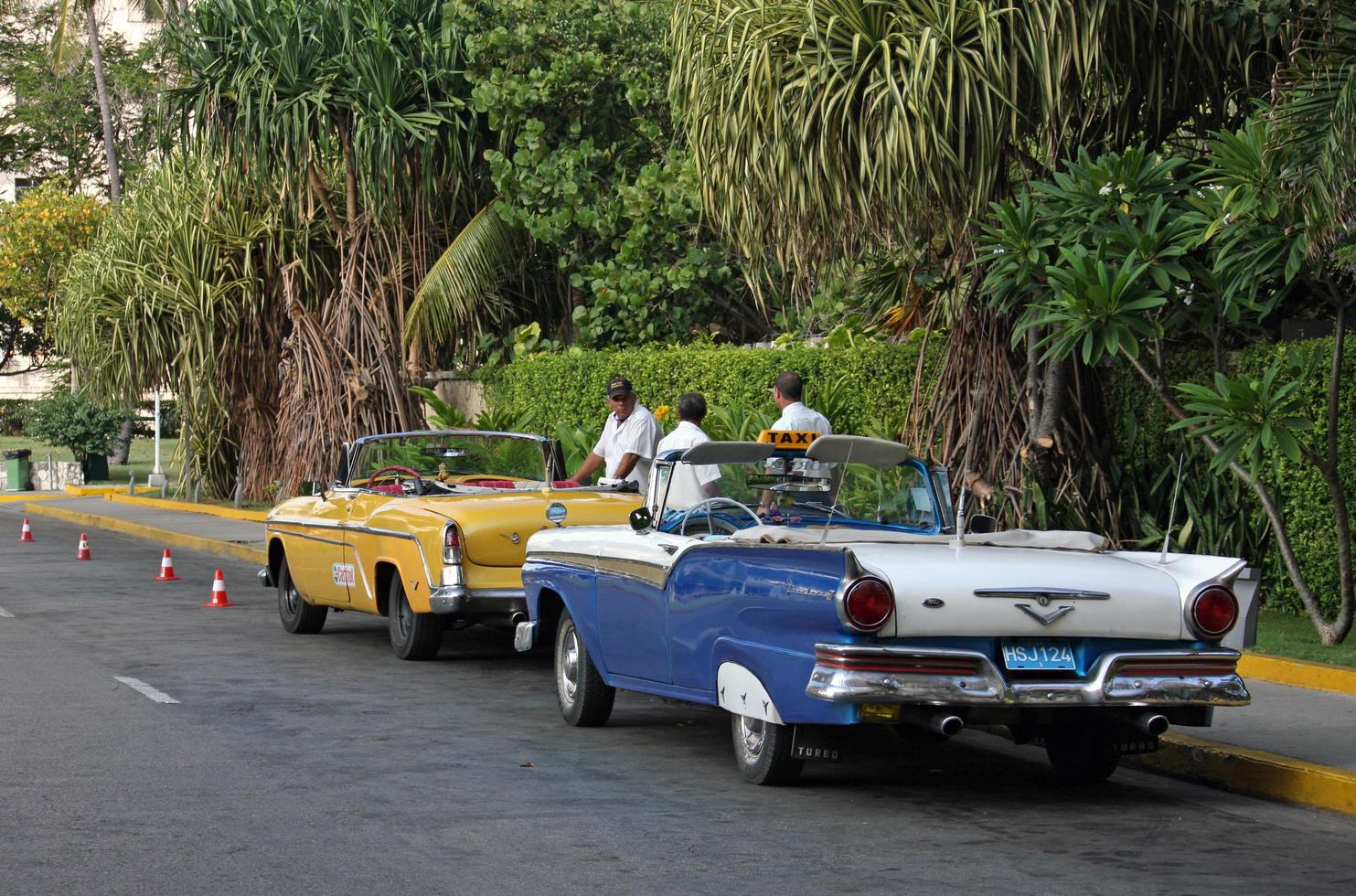 Havana, Cuba - July 2, 2019 - Taxi driver and their classic cars in Havana, Cuba. photo