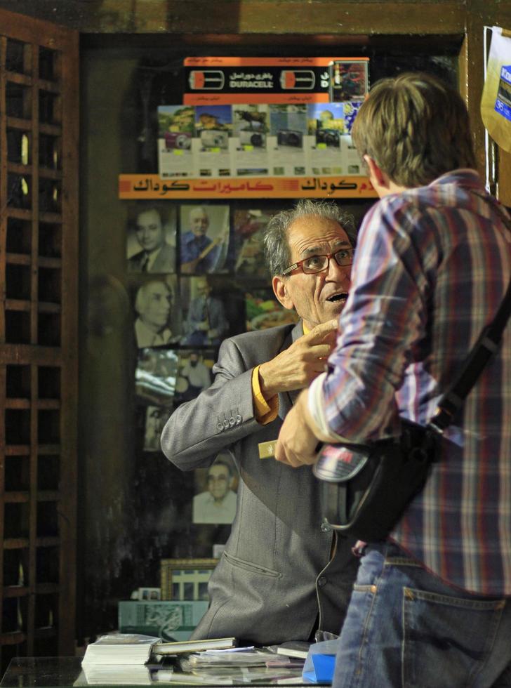 Tehran, Iran - June 10, 2018 - A salesman haggles over prices with a tourist in the bazaar of Tehran. photo