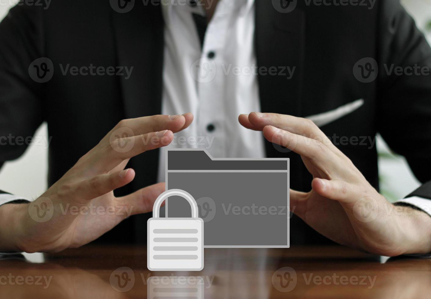 Businessman protecting a secured folder with his hands photo