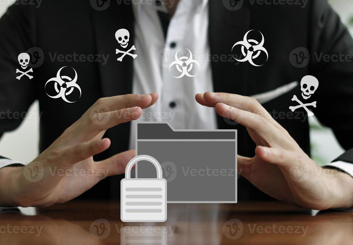 Businessman protecting a secured folder with his hands photo