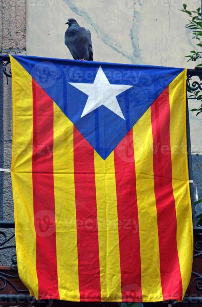 Flag of Catalonia hanging from a balcony in Barcelona photo