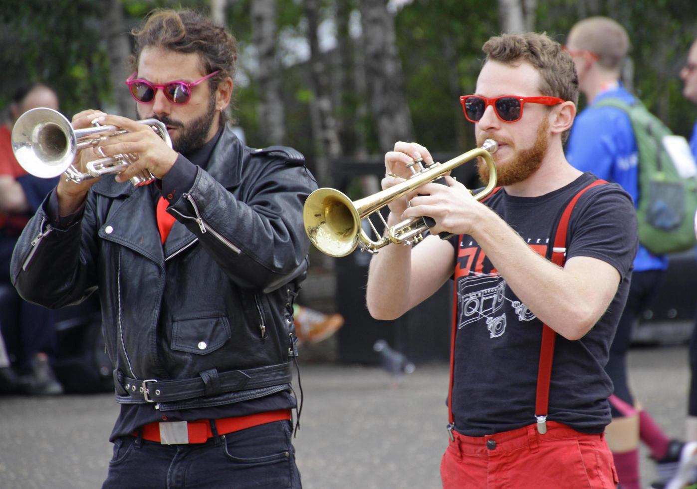 London, UK - September 8 2018 - A saxophone player and a trumpet player wearing sunglasses during a live music performance in London, UK photo