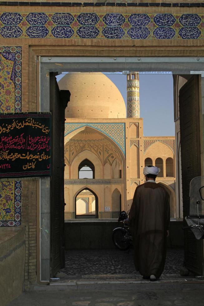 Kashan, Iran - June 14, 2018 - A man enters the square in front of the famous Agha Bozorg Mosque in Kashan Iran. photo