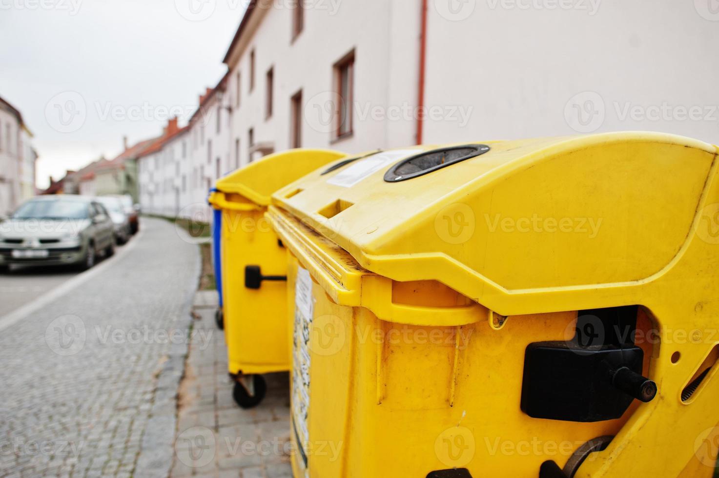 Yellow trash cans for plastic in street. photo
