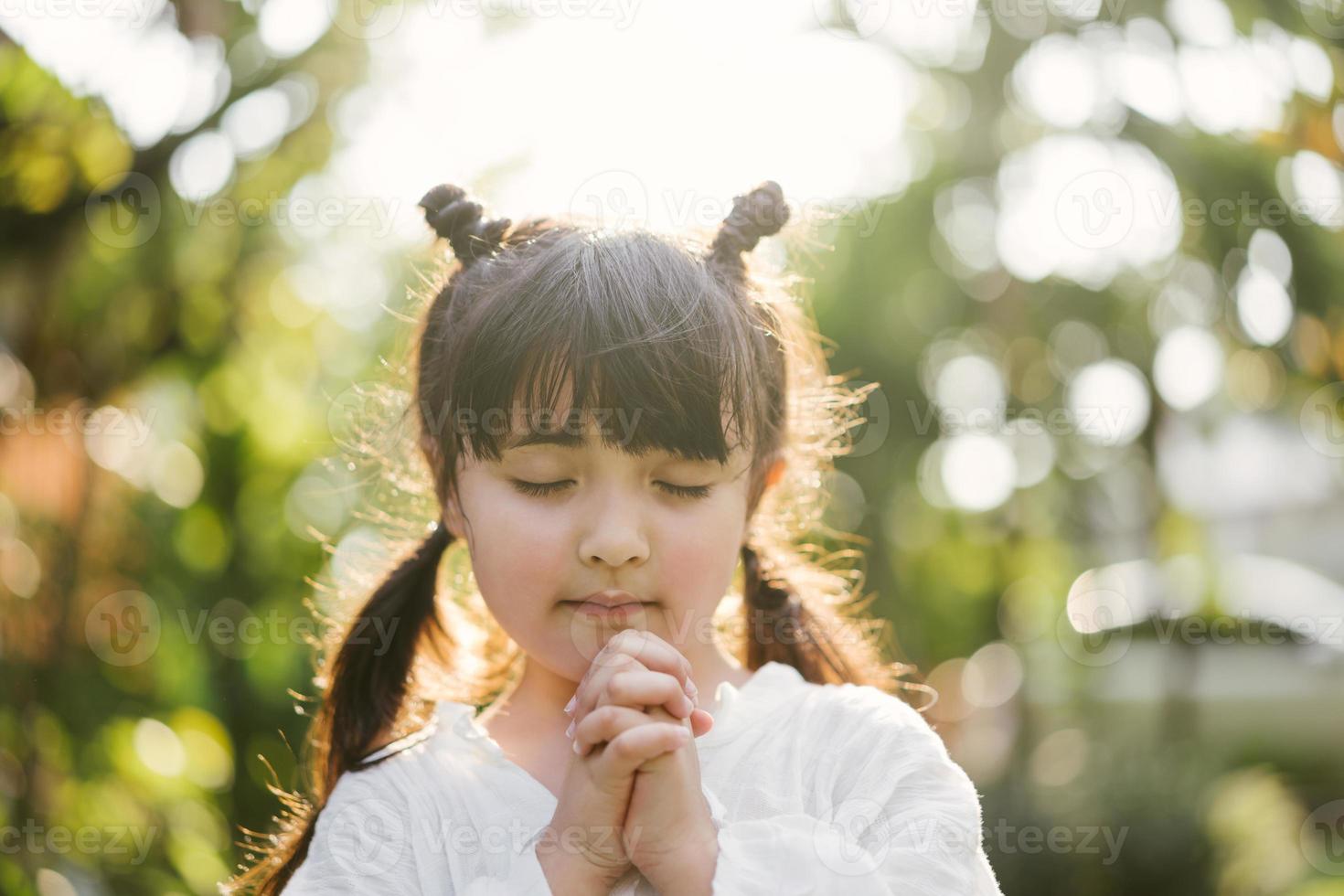 little girl praying. kid prays photo