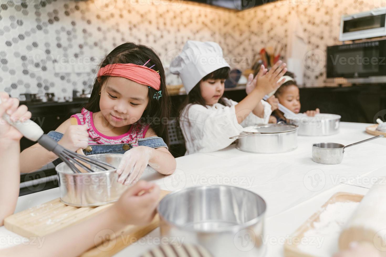 Group of kids are learning to cooking cookie photo