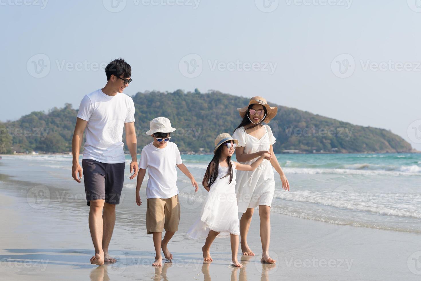 Asian Family walking at beach with kids happy vacation concept photo